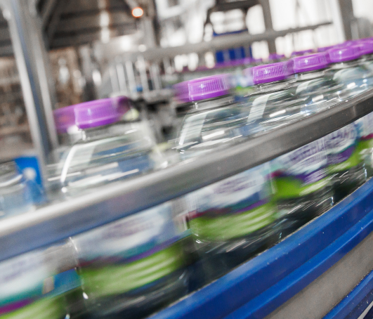 Bowler Beverage Still Water Bottles on a Conveyor Belt.